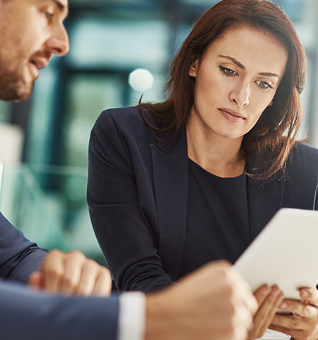 Women and man in a business setting on a conference call